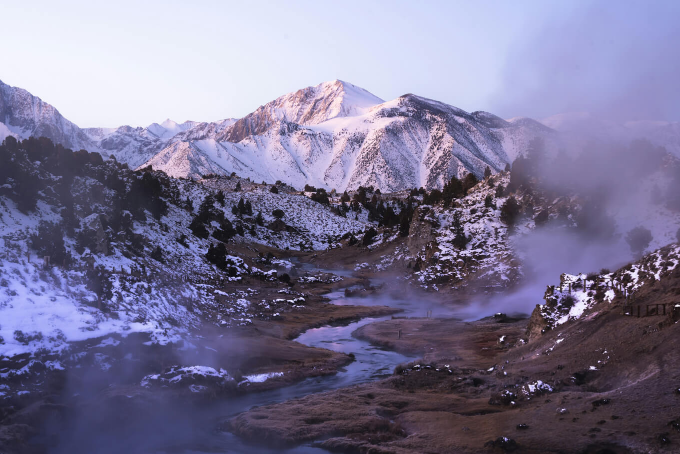 Steam rising from Hot Creek geological site near Mammoth Lakes. Photo by <a href="https://unsplash.com/@bmcornelius?utm_content=creditCopyText&utm_medium=referral&utm_source=unsplash">Brian Cornelius</a> on <a href="https://unsplash.com/photos/a-mountain-range-covered-in-snow-and-steam-fqli_lsxtIo?utm_content=creditCopyText&utm_medium=referral&utm_source=unsplash">Unsplash</a>