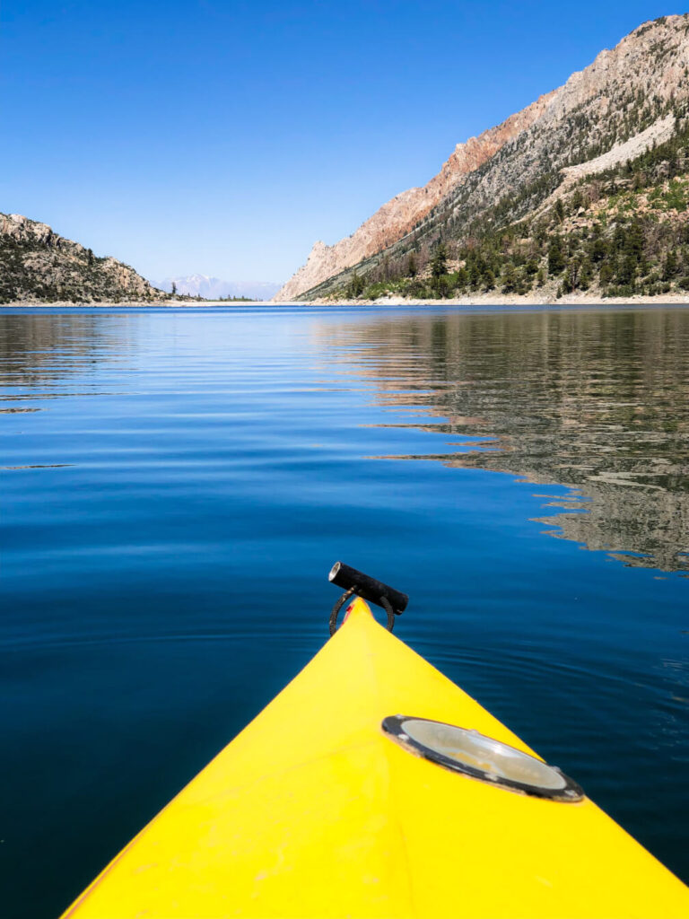 Kayaking on a bright summer day on the glassy surface of Lake Sabrina near Bishop.